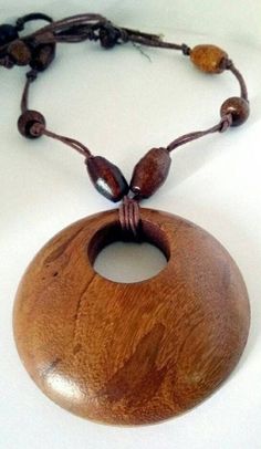 Long Tribal Necklace Round Hand Knotted Large Wood Brown Disc Pendant with Multi Wood  Shaped Beaded  Chunky Long Trendy Huge Round Disc Brown pendant!   Multi shaped wood beaded necklace!  Measure's 28in Length  Pendant  3in x 3in  Perfect Condition! Beautiful Handmade!    Sorry No returns. Insurance OR Special shipping request CAN BE ACCOMMODATED please ask before order :) Beaded Natural Wood Jewelry, Natural Wood Beaded Jewelry, Leather Cord Jewelry, Hand Knotted Necklace, Wood Bead Necklace, Cord Jewelry, Disc Pendant, Wood Jewellery, Leather Cord