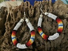 Authentic Beautiful Native American Indian Jewelry Navajo Zuni Hand Beaded  2 3/8inch Hoop Earrings Handcrafted by Navajo Artist Harriet Crosby Great for a  Gift❤️ Present in virtually every Native American tribe, the feather symbol is universally recognized as a representation of trust, strength, wisdom, freedom, and honor. Incorporated into many sacred pieces of Native American wear, the feather is easily one of the most respected symbols. Southwestern Beaded Round Earrings, Southwestern Style Beaded Round Earrings, White Southwestern Beaded Earrings For Festivals, Southwestern Round Beaded Earrings, Southwestern White Beaded Earrings For Festival, White Southwestern Style Beaded Earrings For Festival, Southwestern Style White Jewelry With Dangling Beads, Southwestern Style White Earrings For Festivals, Southwestern White Teardrop Earrings