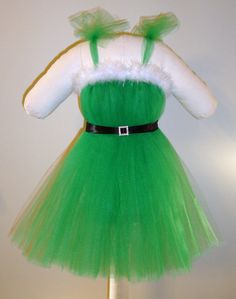 A handmade green Mrs. Claus dress made with tons of tulle to create maximum fullness and coverage. Perfect for Christmas!    The tutu dress is Mrs Claus Dress, Christmas Tutu Dress, Christmas Tutu, Flowing Dress, Custom Gift Wrapping, Hand Stitch, Feather Trim, Flowing Dresses, Mrs Claus