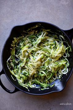 zucchini noodles in a skillet on a table