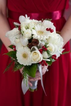 a woman in a red dress holding a white bouquet