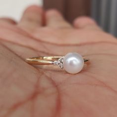 **KINDLY CHECK OUT THE VIDEO OF THE ITEM FOR A CLEARER VIEW**Details of the ring Gemstone: Center Gem: Pearl gem shape,size & weight: Round, 6 mm & 1.15 carats Side Gem: Diamond gem shape,size & weight: Round, 1.20 mm (6 pcs) & 0.04 carats Total Stone Weight: 1.19 carats Metal: GOLD Purity: 14 KT Weight: 1.29 Grams Total weight of the ring: 1.53 grams Beautiful Pearl and Diamond set in 14kt Gold, a perfect gift for a woman. The Gold purity is absolutely guaranteed and it comes wi 14k Yellow Gold Pearl Promise Ring, 14k Gold Pearl Ring With Prong Setting For Promise, 14k Gold Pearl Promise Ring, 14k Gold Pearl Ring With Gemstone For Wedding, 14k Gold Pearl Ring With Gemstone For Anniversary, Fine Jewelry Pearl Ring With Prong Setting, 14k Gold Pearl Ring With Brilliant Cut For Gift, 14k Gold Pearl Ring Fine Jewelry, 14k Gold Brilliant Cut Pearl Ring