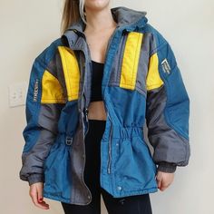 Incredibly Warm Vintage Ski Club Jacket! Mens Size Medium. Model Is Women's Medium Wears As Cozy Oversized Hip Winter Jacket. Comes With Hide Away Hood. 1-800 -Ski Detail On Back Retro Yellow Windbreaker For Winter, Vintage Yellow Windbreaker For Winter, Blue Hooded Ski Season Outerwear, Blue Outerwear For Ski Season, Blue Hooded Outerwear For Ski Season, Blue Sporty Ski Season Outerwear, Retro Yellow Outerwear With Pockets, Blue Sporty Outerwear For Ski Season, Sporty Blue Outerwear For Ski Season