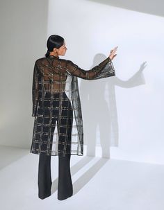 Good for a breezy summer or an evening event, this knee-length jacket features checkered embroidery with rustic gold and black sequins and is one timeless piece you can wear over a dress, a set or even a swimsuit.- Checkered embroidered - Mid-length - Long, flared sleeves - Sheer - Loose-fit - No closures- Fabric: Net Model wears a size XS / bust 32 inches. Short Dress Patterns, Knee Length Jacket, Sheer Jacket, Comfy Chic, Striped Jacket, Black Sequins, Minimal Fashion, Flared Sleeves, Jacket Style