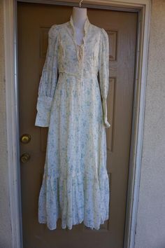 Gunne sax style or possibly Gunne Sax prairie dress. Zippers at the wrists. Laces at the bust. Good condition - has sewn on back under the laces that could be easily removed - see last photo. Measurements taken across front laid flat17.5" across front armpit to armpit13.5" across front of waist (ties tighter)20" across hips59" length Gunne Sax Dress Aesthetic, Spring Victorian Lace Dress For Daywear, Spring Peasant Prairie Dress With Floral Print, Spring Peasant Style Prairie Dress With Floral Print, Spring Floral Print Prairie Peasant Dress, Spring Floral Print Peasant Prairie Dress, Fitted Bohemian Prairie Dress For Spring, Spring Prairie Dress With Long Sleeves, Bohemian Fitted Prairie Dress With Floral Print