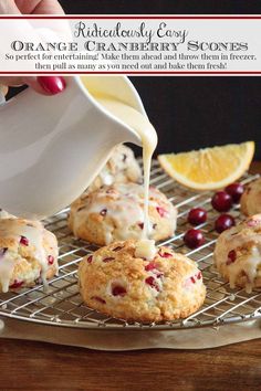 orange cranberry scones with icing being drizzled