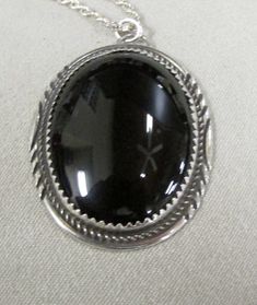 "Sterling silver and black onyx oval pendant. 1 3/8\" tall x 1 1/16\" wide. The 30\" sterling rope chain is included. The pendant is stamped H Sterling. There are some lines on the back of the pendant which appear to have been done on the inside under the stone. I don't know why. Otherwise good condition. PWC-2" Silver Oval Onyx Necklace, Silver Onyx Oval Necklace, Black Round Pendant Necklace Collectible, Black Engraved Oval Pendant Jewelry, Classic Black Oval Pendant Jewelry, Black Oval Engraved Jewelry, Oval Black Engraved Jewelry, Black Oval Jewelry With Large Pendant, Collectible Black Jewelry With Large Pendant