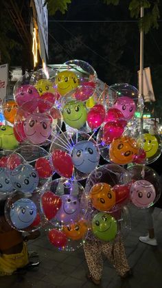 a bunch of balloons that have faces on them