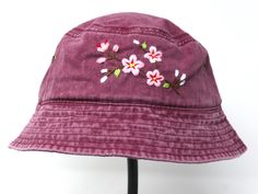 This hand embroidered cotton bucket hat is a stylish accessory that combines function with unique, handmade design. Made from high-quality cotton, it provides comfort and protection from the sun, making it perfect for outdoor activities. The intricate floral embroidery is meticulously crafted by hand, giving each hat a one-of-a-kind touch. Whether you're at the beach, camping, or just running errands, this cotton hat is both practical and fashionable. Item: flower embroidered bucket hat Material: 100% cotton Size: one size fits most Embroidery: hand made with acrylic thread Free first class shipping, upgradable priority mail service. 30 days return policy, feel confident at your purchase! Spring Cotton Hats With Floral Embroidery, Embroidered Cotton Sun Hat For Beach, Bohemian Cotton Bucket Hat For Spring, Casual Embroidered Sun Hat With Curved Brim, Spring Wide Brim Bucket Hat With Embroidered Logo, Casual Cotton Sun Hat With Embroidery, Casual Embroidered Bucket Hat For Beach, Embroidered Bucket Hat For Spring, Embroidered Brimmed Bucket Hat For Spring