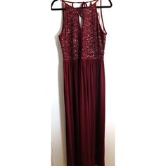 This stunning maroon evening dress from Morgan & Co is a showstopper. Perfect for any holiday or cocktail party, this sleeveless maxi dress will make you feel like a classic beauty. The dress features a solid pattern and a ball gown style, giving you a regal and elegant look. Made for women in size 14, this dress is a must-have for any wardrobe. The long dress length adds to the sophistication of the gown, making it a perfect choice for formal events. The dress comes in a beautiful shade of red that is sure to turn heads. Don't miss out on the chance to own this gorgeous dress.Size 14Pit to Pit: 18Length: 61"Waist: 16" Holiday Gala Floor-length Maxi Dress, Elegant Sleeveless Dress For Holiday Night Out, Floor-length Maxi Dress For Gala And Holiday, Red Sleeveless Maxi Dress For Party Season, Sleeveless Maxi Dress For Evening Holiday Events, Sleeveless Maxi Dress For Evening Holiday, Holiday Evening Floor-length Maxi Dress, Sleeveless Evening Dress For Prom Holiday, Holiday Gala Maxi Dress