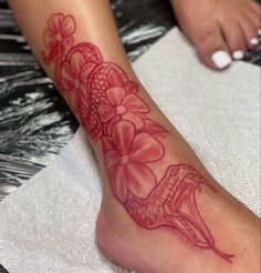 a woman's foot with a tattoo on it