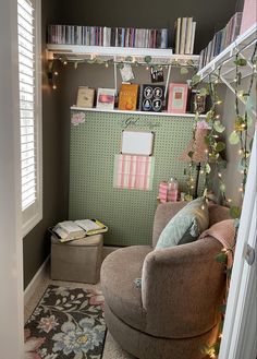 a living room filled with furniture and bookshelves next to a window covered in christmas lights