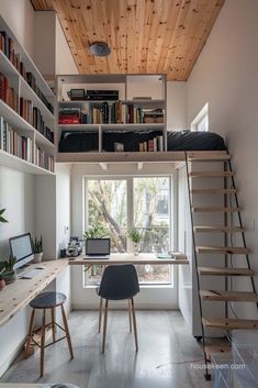 a loft bed with stairs leading up to the top floor and desk area in front of it