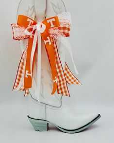 University of  Tennessee, themed Bow Set for your cowgirl boots.  Proudly display your team spirit on your game day fit by adorning your boots with this festive set of bows! Five layers of trendy ribbon add an extra special flair to your day! Quickly clip them to your boot straps with a gold 'o' ring... or use the rear set of ribbons to tie them on.  Spoil yourself with this sassy set of boot bows that capture the essence of Game Day for every Tennessee Girl!  This makes a great gift for any female fan of the Volunteers, or your favorite student at the University ofTennessee!  ✨ * Five Layers of Coordinated ribbon in various sizes. * Metal 'O' Ring  *Colors may vary slightly in person due to monitor settings. *Some ribbons may be substituted for a similar style and like quality, based on a Homecoming Overalls, Game Day Fits, Tennessee Outfits, Tennessee Girls, Gameday Outfits, The Volunteers, Rocky Top