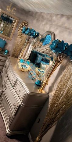 an ornate dresser is adorned with blue and gold accessories