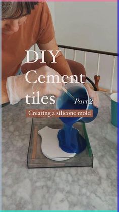 a man is pouring something into a blue cup on top of a table with the words diy cement tiles part 2