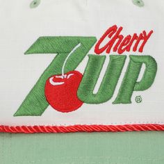 Step back in time with this white 7UP snapback hat, showcasing a retro grandpa shape that exudes vintage charm. The green curved bill perfectly complements the red and green letters spelling out "Cherry 7UP," creating a nostalgic aesthetic. Crafted from ripstop cotton fabric, this hat ensures durability and comfort. The adjustable snapback closure allows for a customized fit, making it suitable for every head size. Hand wash it in cold water and lay it flat to dry for easy care. Elevate your sty Retro Trucker Hat With Embroidered Logo, Green Retro Hat With Letter Print, Retro Green Hat With Letter Print, Retro Baseball Cap With Embroidered Logo, Retro Letter Print Baseball Cap, Green Retro Snapback Hat, Retro Green Snapback Hat, Retro Green Baseball Cap With Curved Bill, Green Retro Baseball Cap With Letter Print