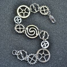 "A mechanical manifestation of your interest in steampunk, my gear bracelet in sterling silver is made to clasp your wrist as you boldly go forth on your daily adventures. This bracelet is constructed with 5 different gears linked together with soldered jump rings in a line. This bracelet uses 2 different wheels, 1 escape wheel, 1 balance wheel and 1 flywheel. These gears are all cast using the lost-wax process. The total length of this bracelet is 8\". The individual gears range from 1/2\" (9 m Silver Metal Bracelet With Custom Hardware, Silver Stainless Steel Jewelry With Custom Hardware, Steampunk Silver Bracelet As Gift, Silver Steampunk Bracelet As Gift, Silver Steampunk Bracelet For Gift, Steampunk Metal Bracelet Jewelry, Steampunk Metal Bracelet, Silver Bracelet With Custom Hardware, Steampunk Fashion Women