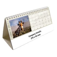 a desk calendar with a giraffe photo on it