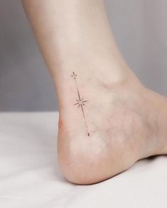 a person with a small star tattoo on their foot