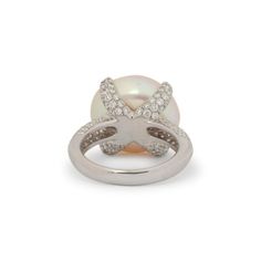 Gender: Ladies    Metal Type: 18K White Gold    Ring size: 6.5    Total weight: 9.88 grams    Natural pearl 18K white gold diamond cocktail ring with a half round shank.    Engraved with "18K".  Pre-owned Excellent condition. Might show minor signs of wear.    Prong Set in 18 Karat White Gold with:    One (1) natural, oval-shaped, cabochon cut, pearl:    Species: Natural Pearl  Variety: Natural Pearl  Measurements: 16.60mm x 15.02mm x ~10.00mm in depth.  Estimated Weight: 14.14 ct.  Cut Style: Crown Cabochon Cut  Color(s): Very Strongly White  Pavé set in 18 Karat White Gold with:    One hundred eighteen round brilliant cut natural diamonds:    Measurements: 1.40mm - 1.80mm in diameter x ~0.98mm in depth.  Weight Range: 0.013 ct. - 0.023 ct.  Estimated Total Weight: 2.120 ct.  Color: F - G Formal Brilliant Cut Pearl Ring In Platinum, Diamond Pearl Ring With Pave Setting For Formal Events, Diamond Pearl Ring With Pave Setting For Formal Occasions, White Gold Pearl Ring With Pave Diamond Setting, White Gold Pearl Ring With Diamond Pave Setting, White Gold Pearl Ring With Pave Setting, Formal Diamond Pearl Ring With Pave Setting, Oval Diamond Pearl Ring In Diamond White, Diamond Pearl Ring With Polished Finish