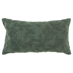 a green pillow with leaves on it