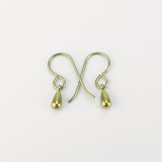 "Tiny gold color anodized titanium teardrop earrings are a pretty staple piece for your sensitive ears. They dangle from titanium French earwires hooks. The titanium is colored through anodizing, this makes the outer layer thicker with titanium and doesn't add other metals, so it is still pure titanium, but colored a beautiful yellow gold. These earrings are completely made out of pure titanium findings and therefor safe for when you have severe nickel allergies. Simple jet feminine for everyday Gold Hypoallergenic Teardrop Earrings For Everyday, Adjustable Gold Teardrop Earrings With Ear Wire, Adjustable Gold Teardrop Earrings, Minimalist Hypoallergenic Metal Teardrop Earrings, Gold Hypoallergenic Brass Teardrop Earrings, Brass Teardrop Drop Earrings For Pierced Ears, Gold Hypoallergenic Teardrop Earrings Gift, Hypoallergenic Gold Teardrop Brass Earrings, Hypoallergenic Gold Teardrop Earrings In Brass