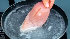 a piece of fish is being cooked in a frying pan