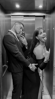 a man standing next to a woman in a elevator