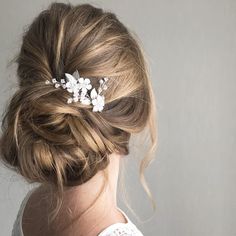 a woman wearing a hair comb with flowers in it