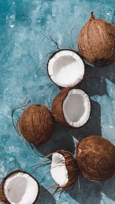 three coconuts with one cut in half and the other whole