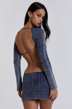 the back of a woman wearing a blue and white striped bodysuit