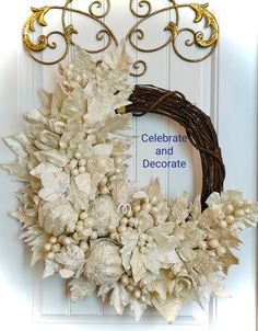 a wreath with white flowers and gold accents hangs on the front door to celebrate and decorate