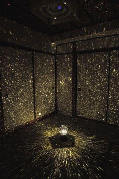 a room filled with lots of stars in the ceiling and lights shining down on it