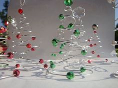 a glass christmas tree with red, green and white ornaments hanging from it's branches