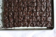 a pan filled with brownies sitting on top of a table