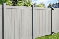 a gray fence in front of a house