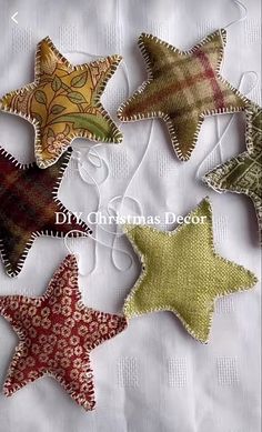 four star shaped ornaments are sitting on a white tablecloth with the words diy christmas decorations