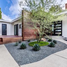 a modern house with landscaping in the front yard