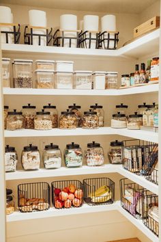 an organized pantry filled with lots of food and storage bins on the shelves,