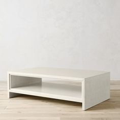 a white coffee table sitting on top of a hard wood floor