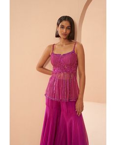 Candy Pink Sharara Set - Parul Gandhi Embrace elegance in this tonal pink sharara set, showcasing a peplum top adorned with a cutwork neckline. The harmonious blend of shades and the intricate detailing add a touch of sophistication to this ensemble, making it a perfect choice for those seeking a graceful and contemporary ethnic look. Included in Purchase: Sharara Top, Pant & Dupatta Product Specification Color: Hot Pink Fabric: Mesh and Organza Neckline: Square Neckline Occasion: Bridal, Engage Bollywood Style Pink Peplum Sets, Pink Peplum Bollywood Sets, Pink Sharara With Resham Embroidery, Bollywood Style Pink Sleeveless Palazzo Set, Pink Sleeveless Bollywood Palazzo Set, Pink Bollywood Style Sleeveless Palazzo Set, Pink Sleeveless Palazzo Set For Party, Sleeveless Pink Palazzo Set For Party, Festive Pink Ruffled Sharara