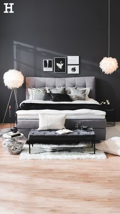 a large bed sitting on top of a hard wood floor next to a white rug