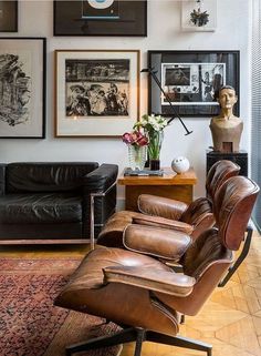 a living room filled with furniture and pictures on the wall