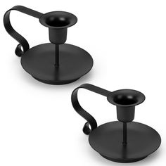 two black candlesticks sitting on top of each other