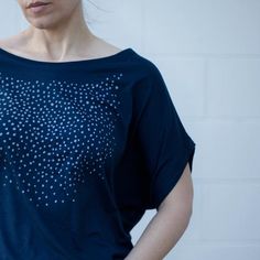 Our original Meteor Shower design has been hand-printed in pale gray water-based ink onto deep navy blue dolman sleeve tops. These shirts have a wide neckline and can be worn off the shoulder. They have a feminine, dramatic drape that tapers down to a fitted hip. FIT & SIZING:- Available in sizes S-2XL- Intended to drape loosely throughout chest and upper body- Tailored for a *SNUG FIT* in the hips- Model shown is 5'8 and a size 4. She's wearing a medium.GARMENT DETAILS & CARE INSTRUCTIO Celestial Clothing, Boho Womens Clothing, Batwing Sleeve Top, Boho Style Tops, Flowy Shirt, Meteor Shower, Dolman Sleeve Tops, Loose Fitting Tops, Shower Screen