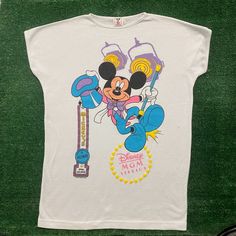 a white shirt with mickey mouse on it