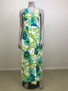 "Vintage Hawaiian halter neck dress. Gorgeous open back. Vibrant green and blue floral pattern. In great condition but does have a small mark on one side. Fits S  26\" underbust  40\" waist 54\" length" Green Floral Print Summer Halter Dress, Green Maxi Halter Dress For Beach, Green Maxi Length Halter Dress For Beach, Green Maxi Halter Dress For The Beach, Green Vintage Dress For Vacation, Green Floral Print Halter Neck Maxi Dress, Vacation Lined Green Maxi Dress, Vacation Green Lined Maxi Dress, Green V-neck Halter Dress For The Beach