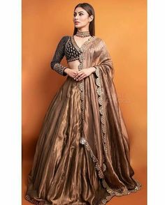 a woman in a brown lehenga