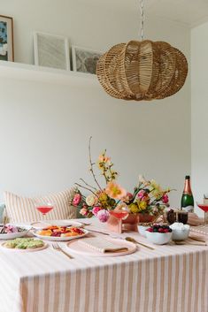 a dining room table set with plates and flowers